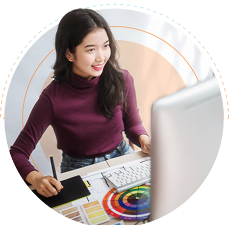 An outsourced creative services professional working on a computer to create a design