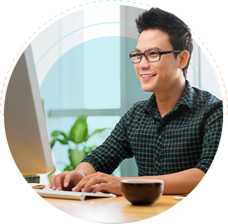 An outsourced data analyst working on a computer